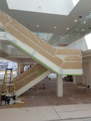 Before picture of staircase onsite at Land Rover showroom, Southend, Essex. Staircase and handrails were polyester filled, primed and top coated onsite.