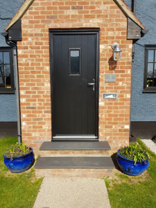 Front door coated onsite in Stansted in special uPVC paint RAL 9011.