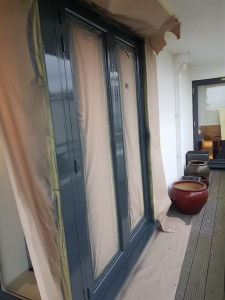 Masking and prep of aluminum refurbishment doors for luxury flats in Frinton-on-Sea, Essex.