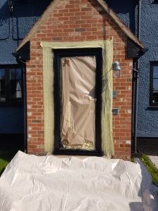 Preparation for coating a uPVC front door onsite in Stansted.