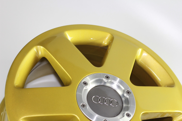 Audi wheel powder coated in gold sparkle.