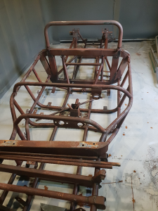 Car chassis awaiting shot blasting in our blast room.
