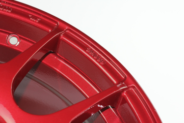 Close up of powder coated wheel in Cherry Red.